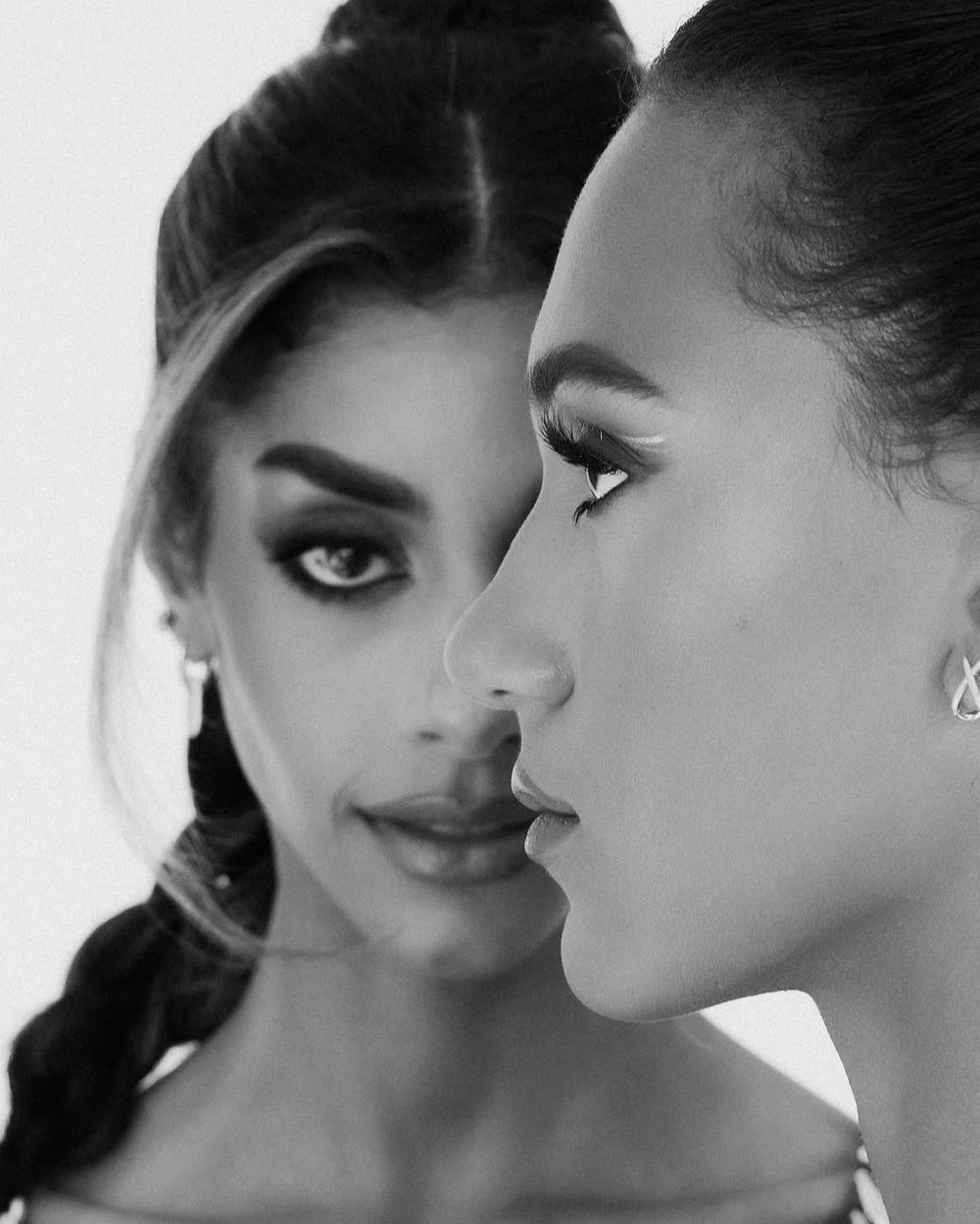 Black and white portrait of two women, one in profile in front of the other